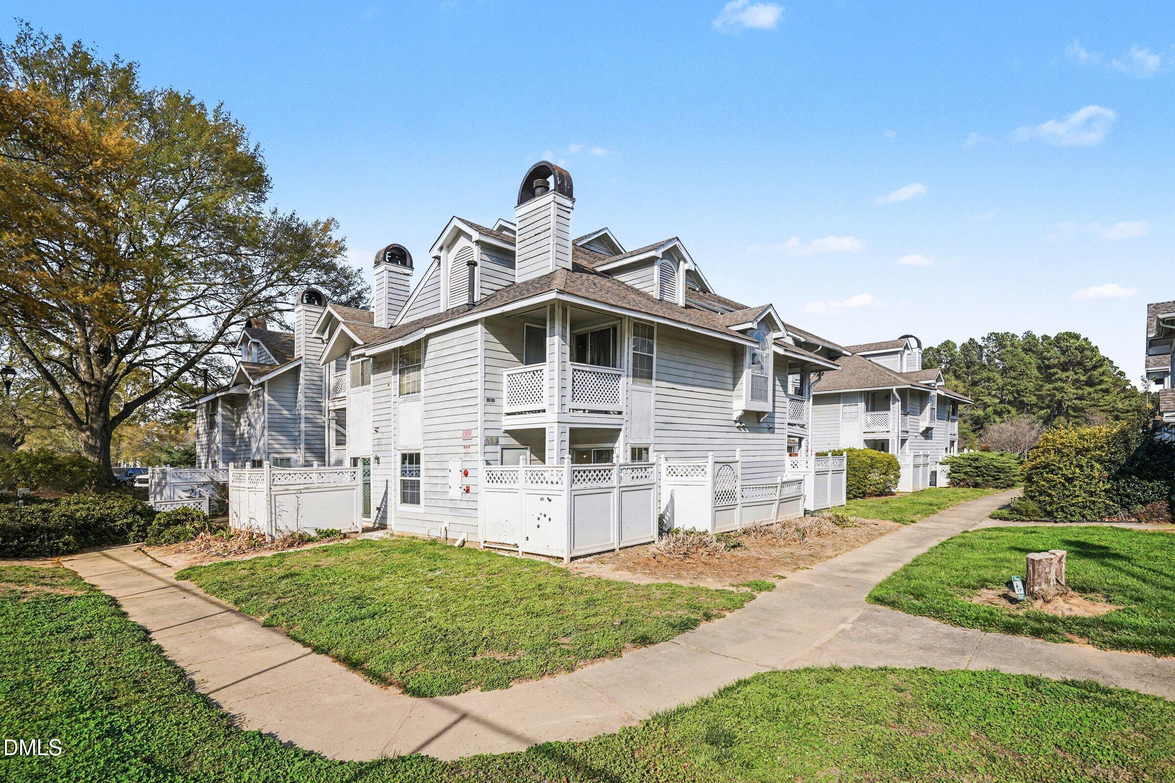 3806 Grey Harbor Drive, Unit 204 Raleigh, NC 27616 - Photo 15 of 18 a front view of a house with a yard
