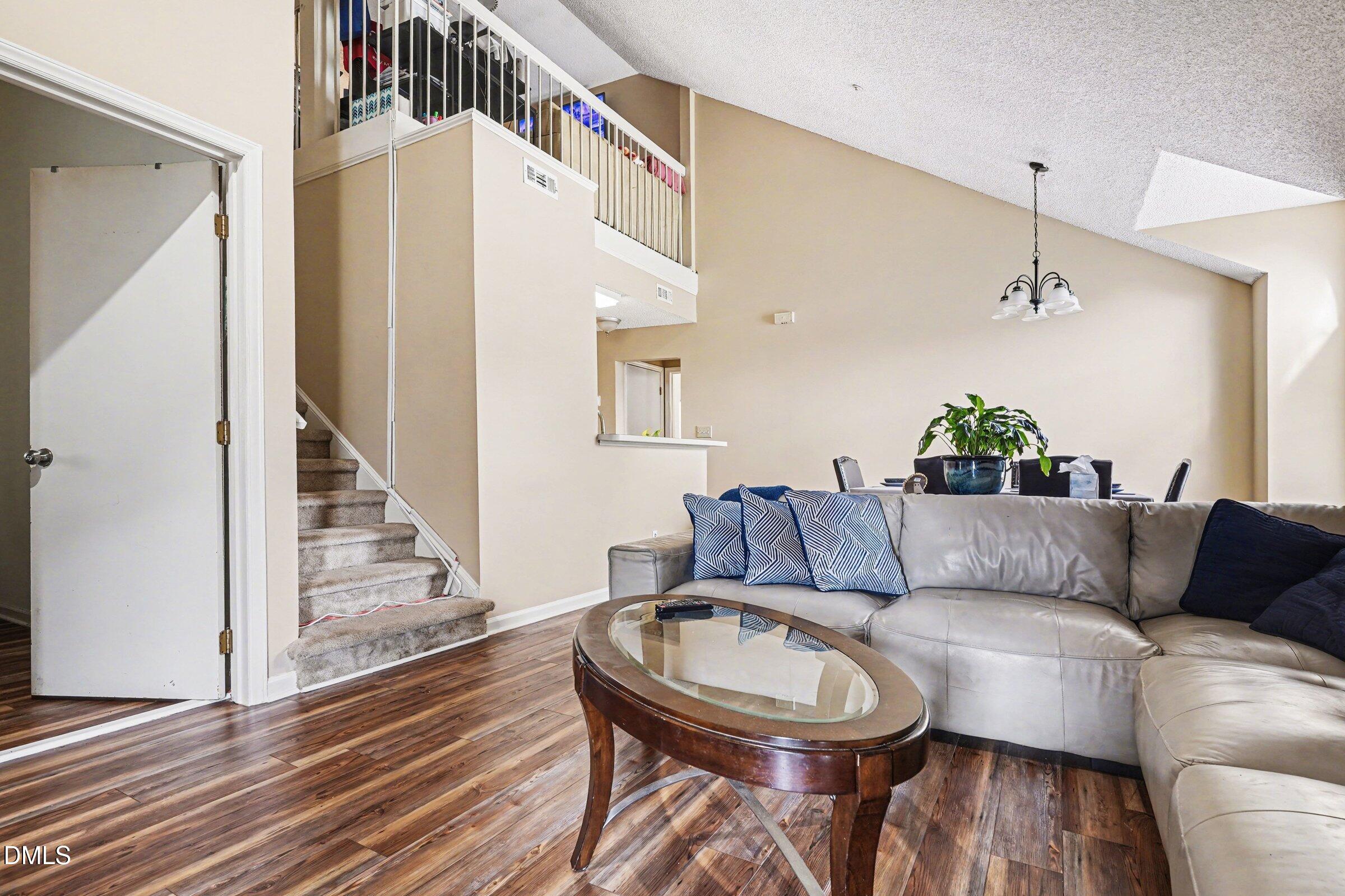 3806 Grey Harbor Drive, Unit 204 Raleigh, NC 27616 - Photo 4 of 18 a living room with furniture and a wooden floor