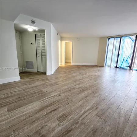 a view of a livingroom with wooden floor and window
