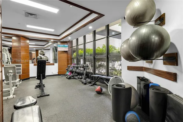 a view of a room with wooden floor and windows