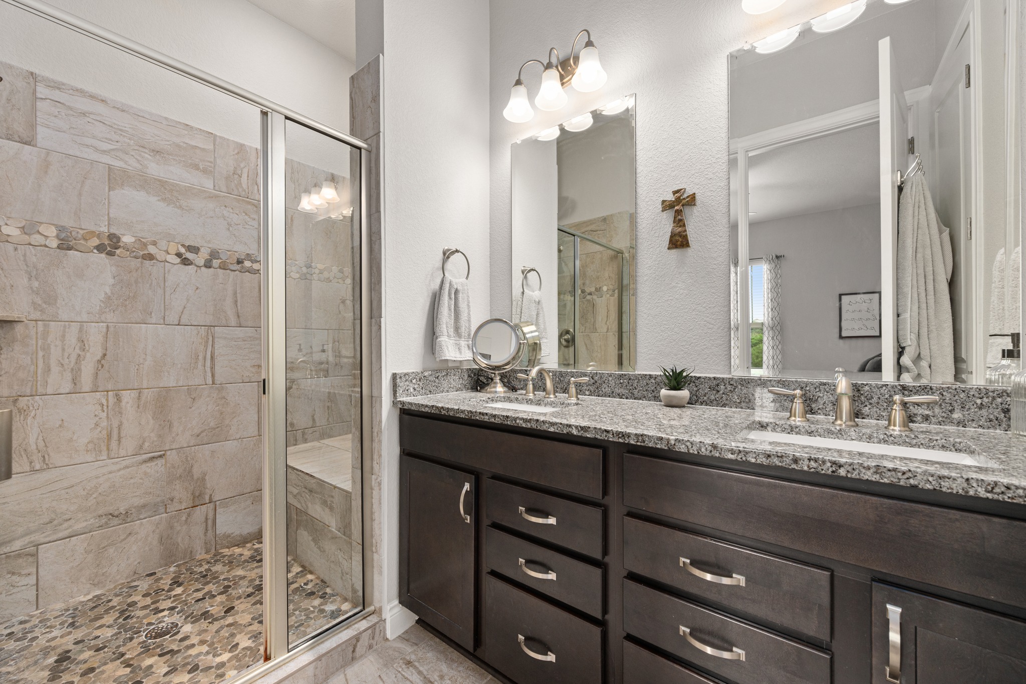 372 Adams Street Georgetown, TX 78628 - Photo 20 of 33 Bathroom with a tiled walk-in shower featuring a built-in bench, double shower heads, vanity with granite