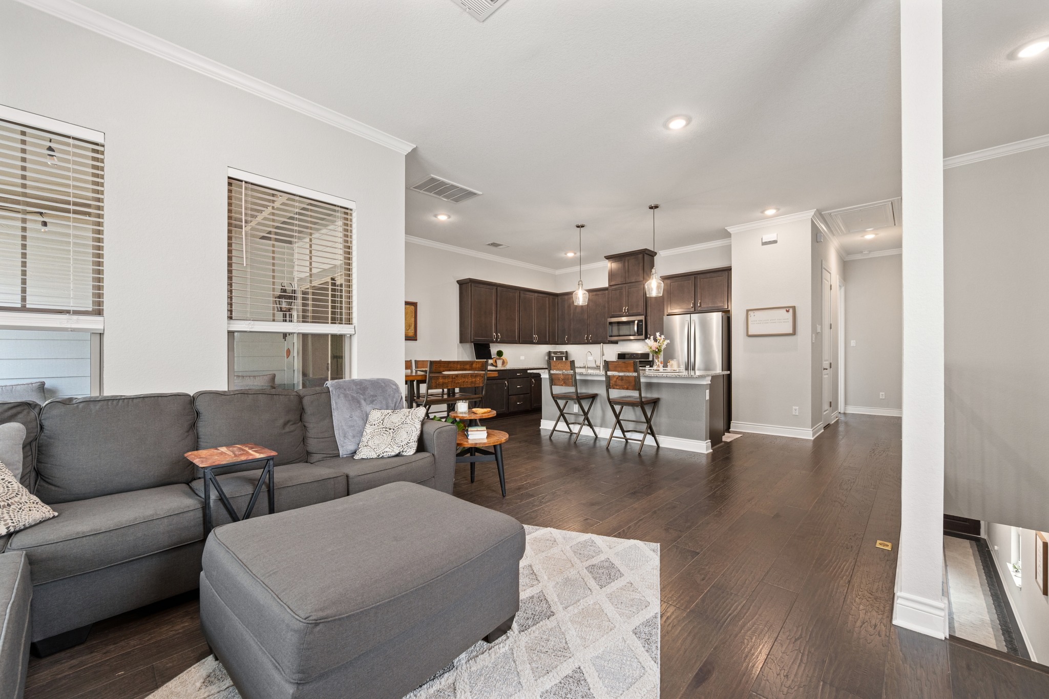 372 Adams Street Georgetown, TX 78628 - Photo 7 of 33 Open concept living with hardwood flooring, recessed lighting, and crown molding