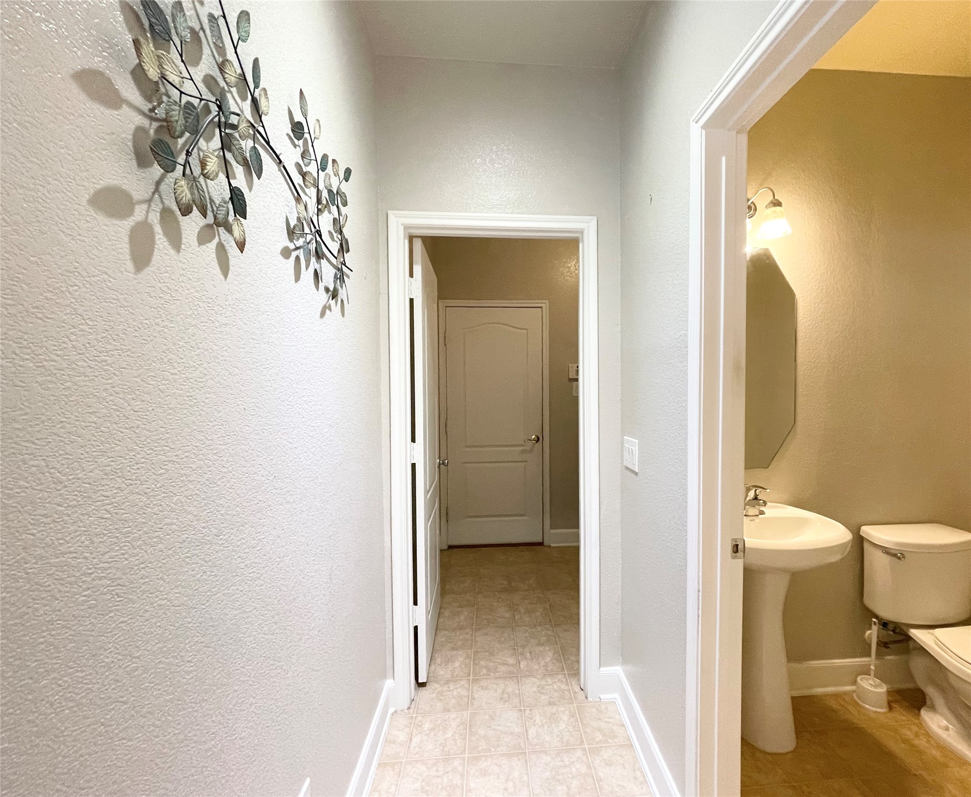 2707 Volute Houston, TX 77038 - Photo 10 of 28 Hall to downstairs half bath and utility room.