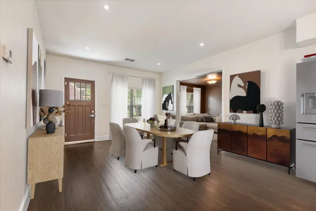 a living room with fireplace furniture and a wooden floor