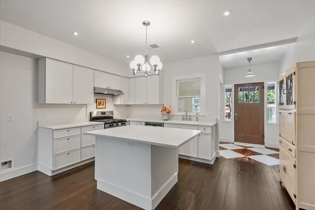 a kitchen with cabinets a sink and appliances