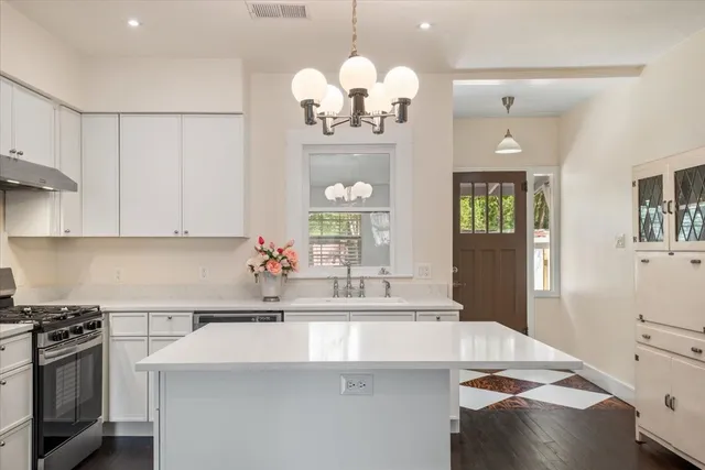 a kitchen with a sink and chandelier