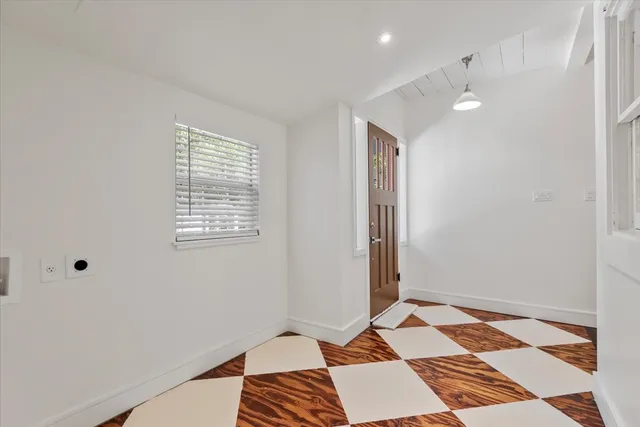 a bedroom with bed tv and window