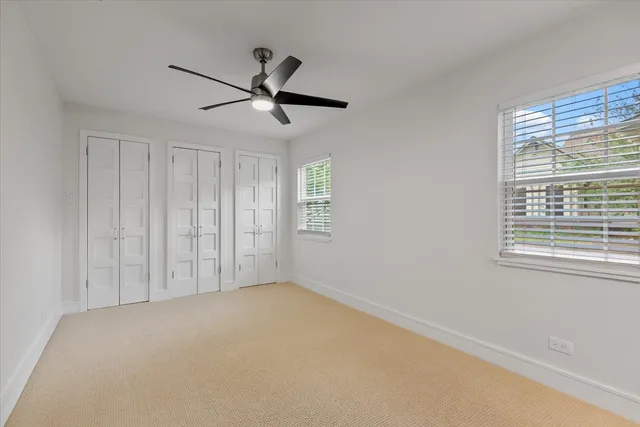 a view of a hallway with a chandelier fan