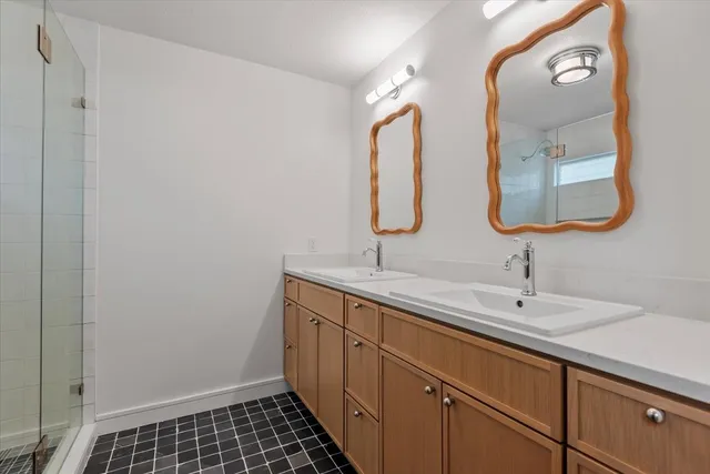 a bathroom with 2 sink and a mirror