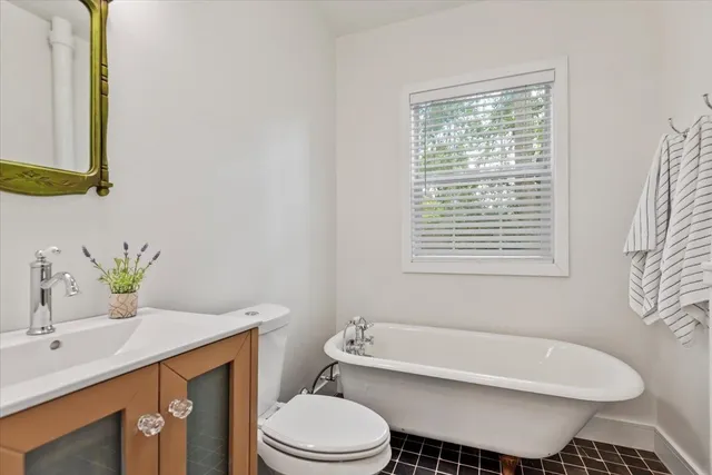 a bedroom with 2 bed and window