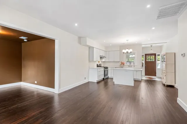 a view of kitchen dining table chairs microwave and cabinets