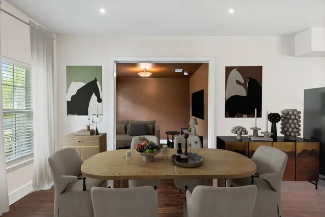 a dining room with furniture and wooden floor