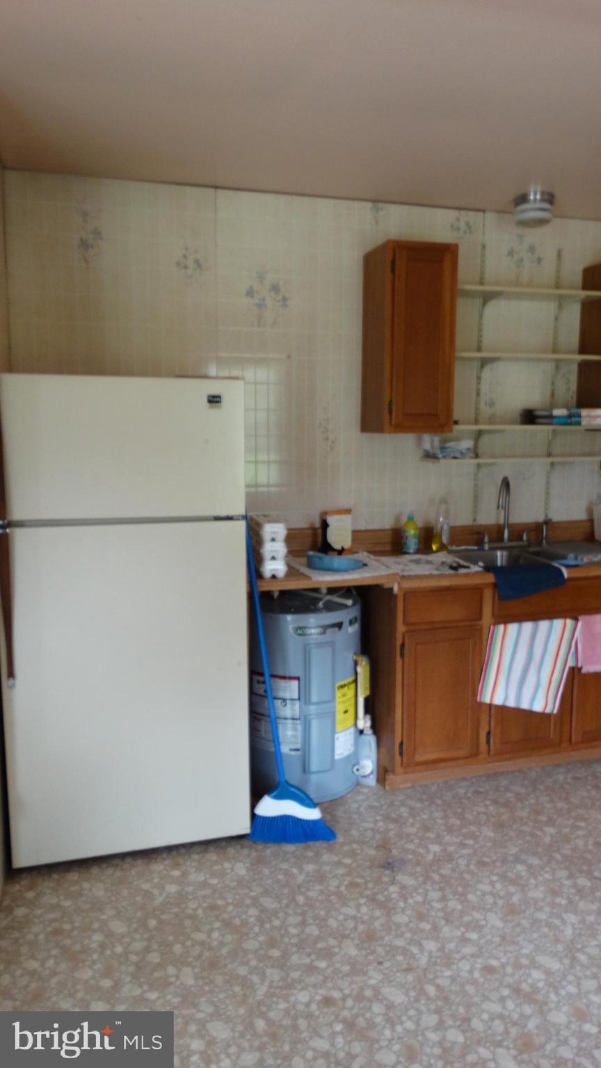22209 Pondsville Road Smithsburg, MD 21783 - Photo 41 of 55 a kitchen with a refrigerator and a stove