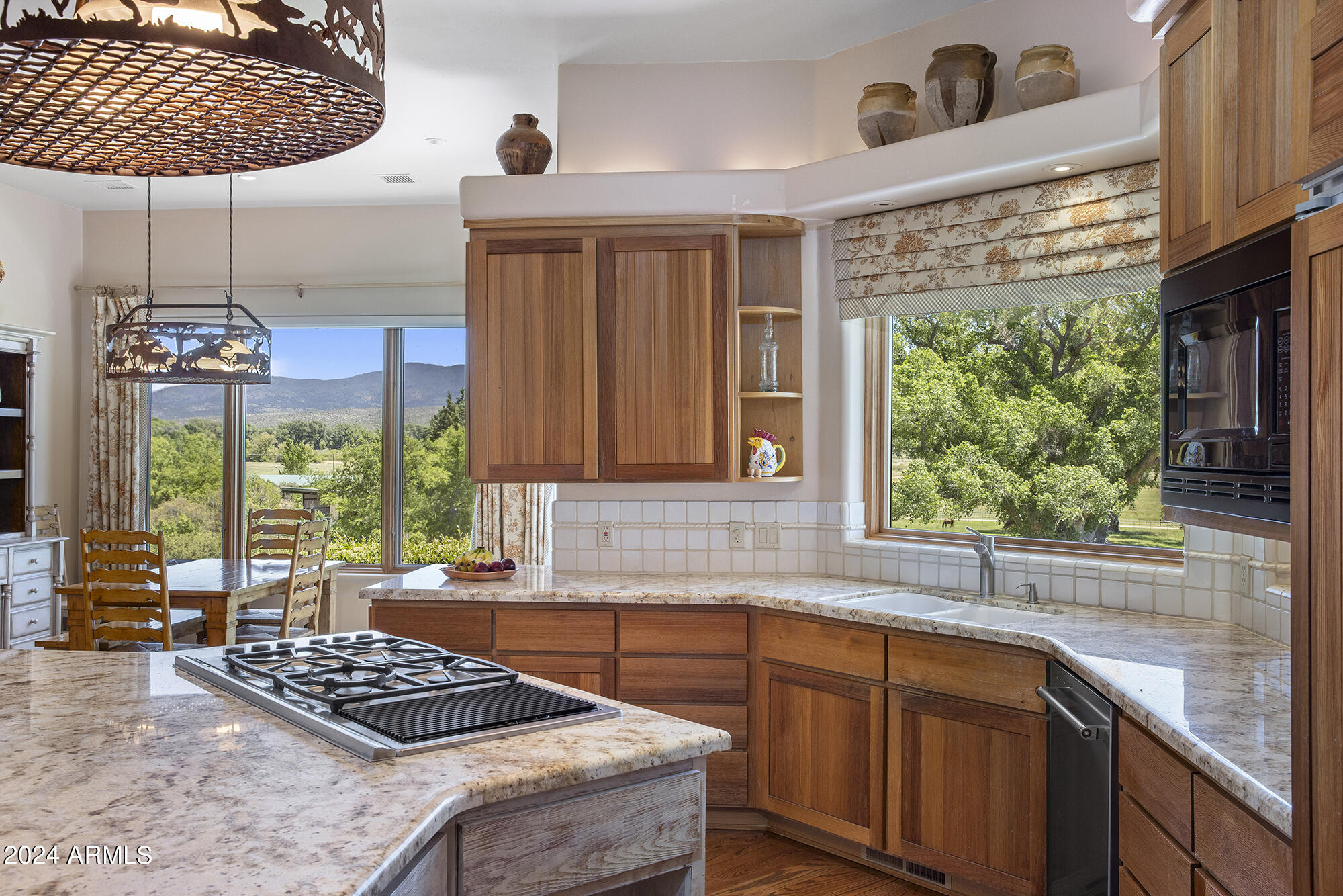 5500 Four Cross Ranch Road Skull Valley, AZ 86338 - Photo 11 of 59 a kitchen with stainless steel appliances granite countertop a stove a sink and a microwave