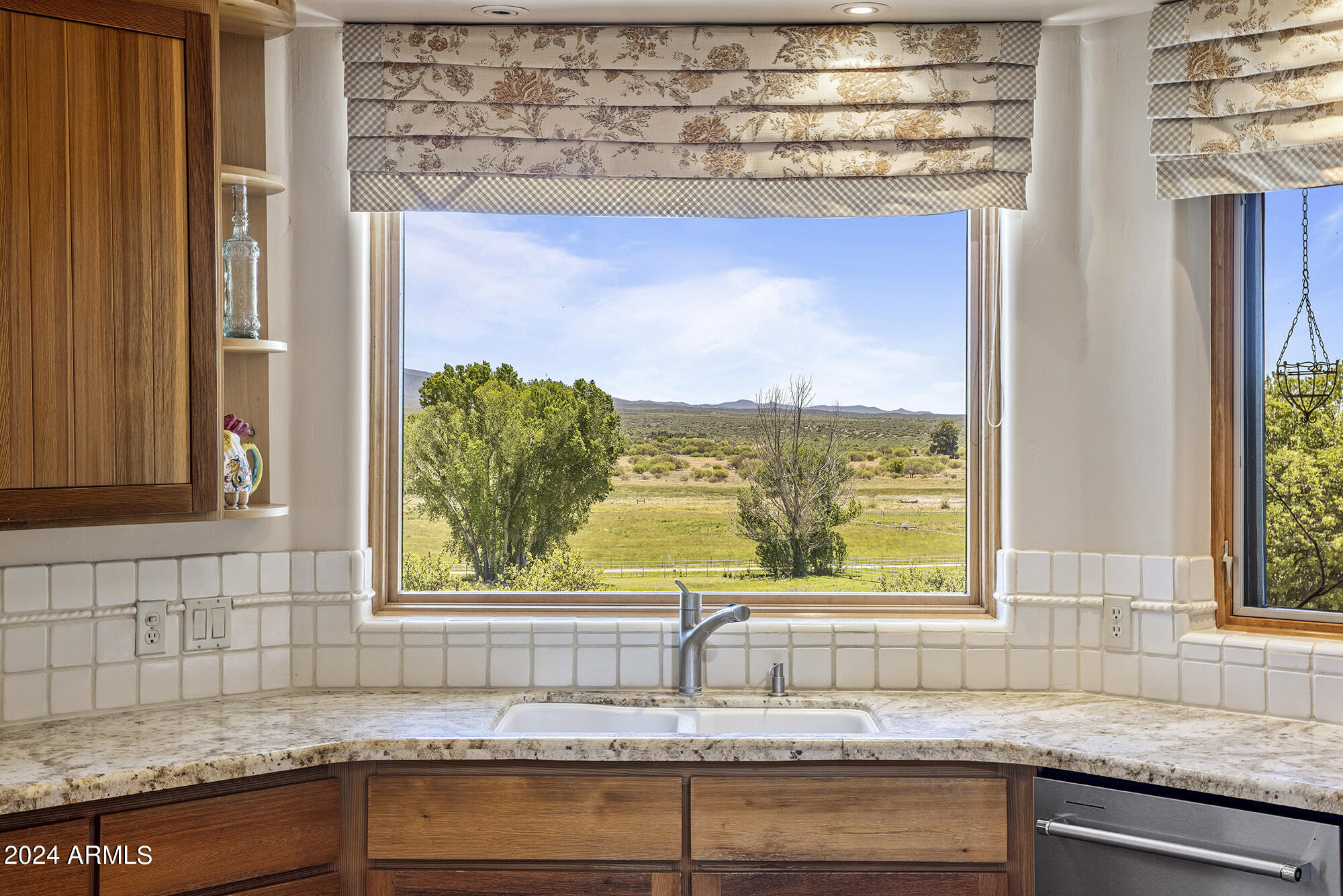 5500 Four Cross Ranch Road Skull Valley, AZ 86338 - Photo 12 of 59 a kitchen with granite countertop a sink and a window