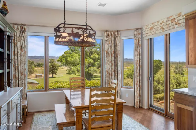 a bathroom with a granite countertop toilet a sink and a mirror