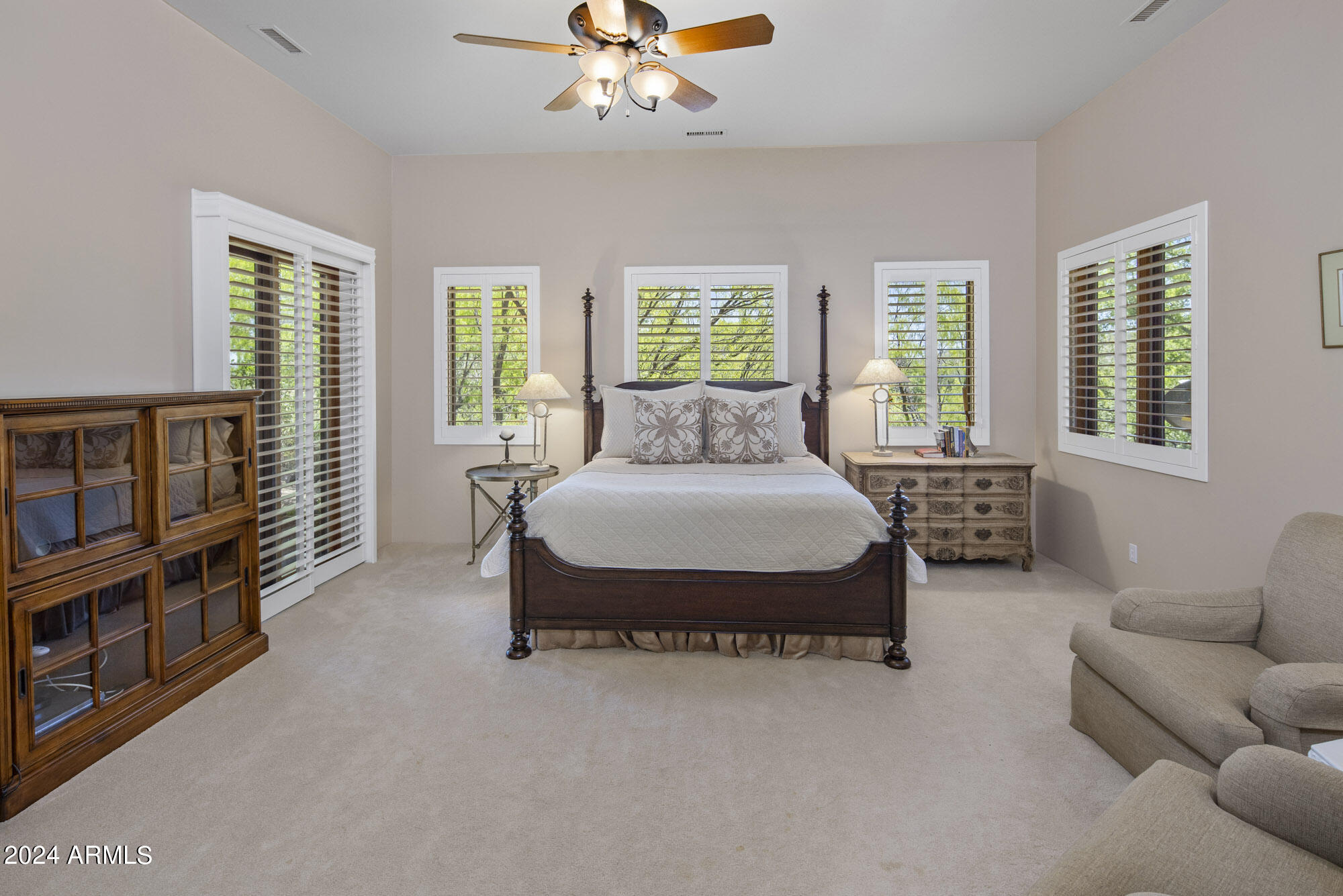 5500 Four Cross Ranch Road Skull Valley, AZ 86338 - Photo 17 of 59 a spacious bedroom with a bed a couch and a chandelier