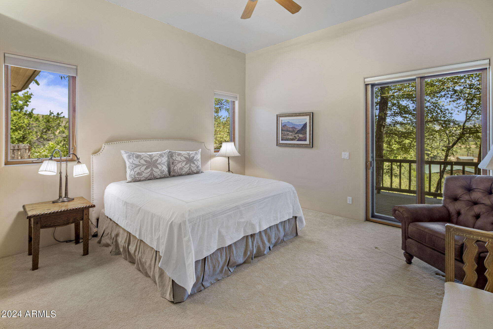 5500 Four Cross Ranch Road Skull Valley, AZ 86338 - Photo 26 of 59 a bedroom with a bed and a couch next to a window