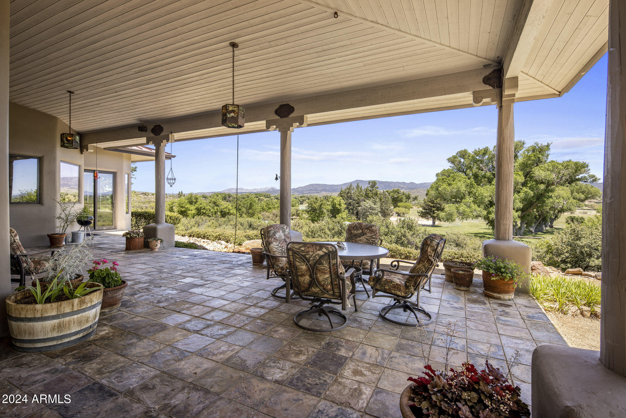 5500 Four Cross Ranch Road Skull Valley, AZ 86338 - Photo 29 of 59 a view of a patio with table and chairs potted plants