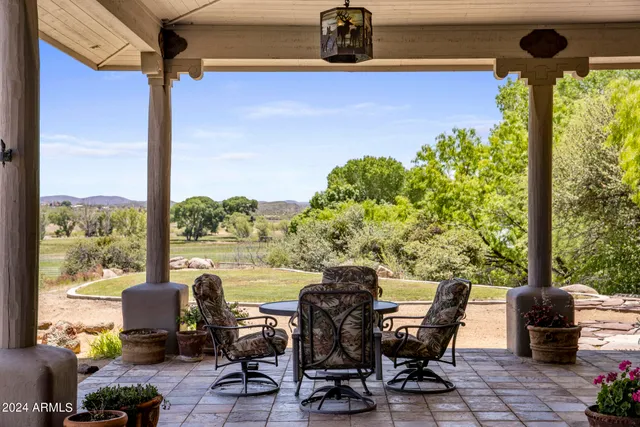 a view of chair and potted plant in front of a glass door