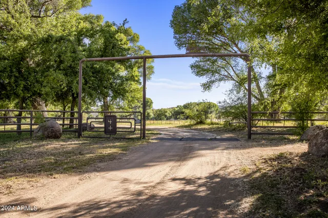 a view of a yard with wooden fence