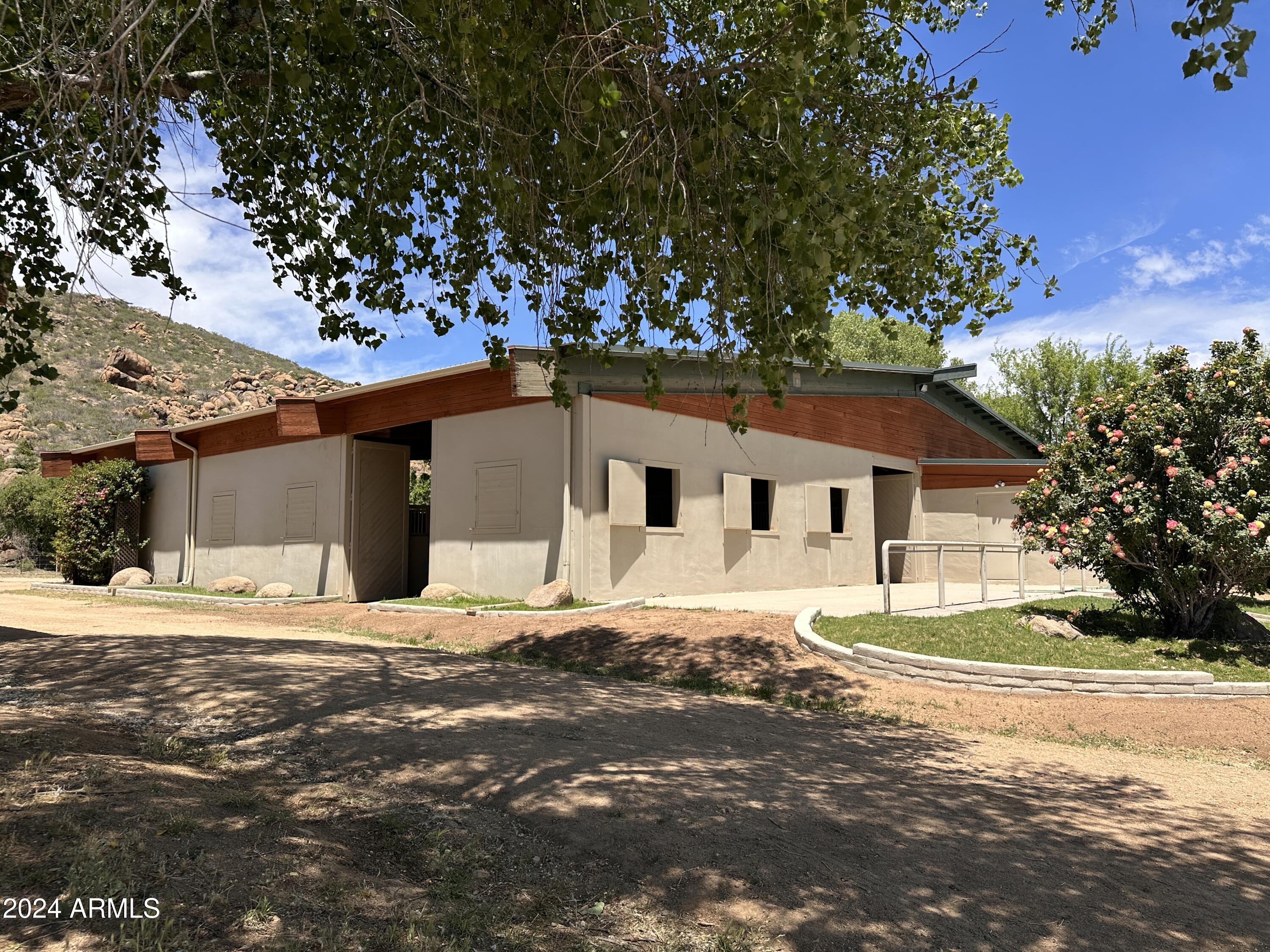 5500 Four Cross Ranch Road Skull Valley, AZ 86338 - Photo 35 of 59 a big house with a big yard and large trees