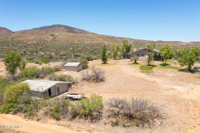 a view of a house with a mountain yard