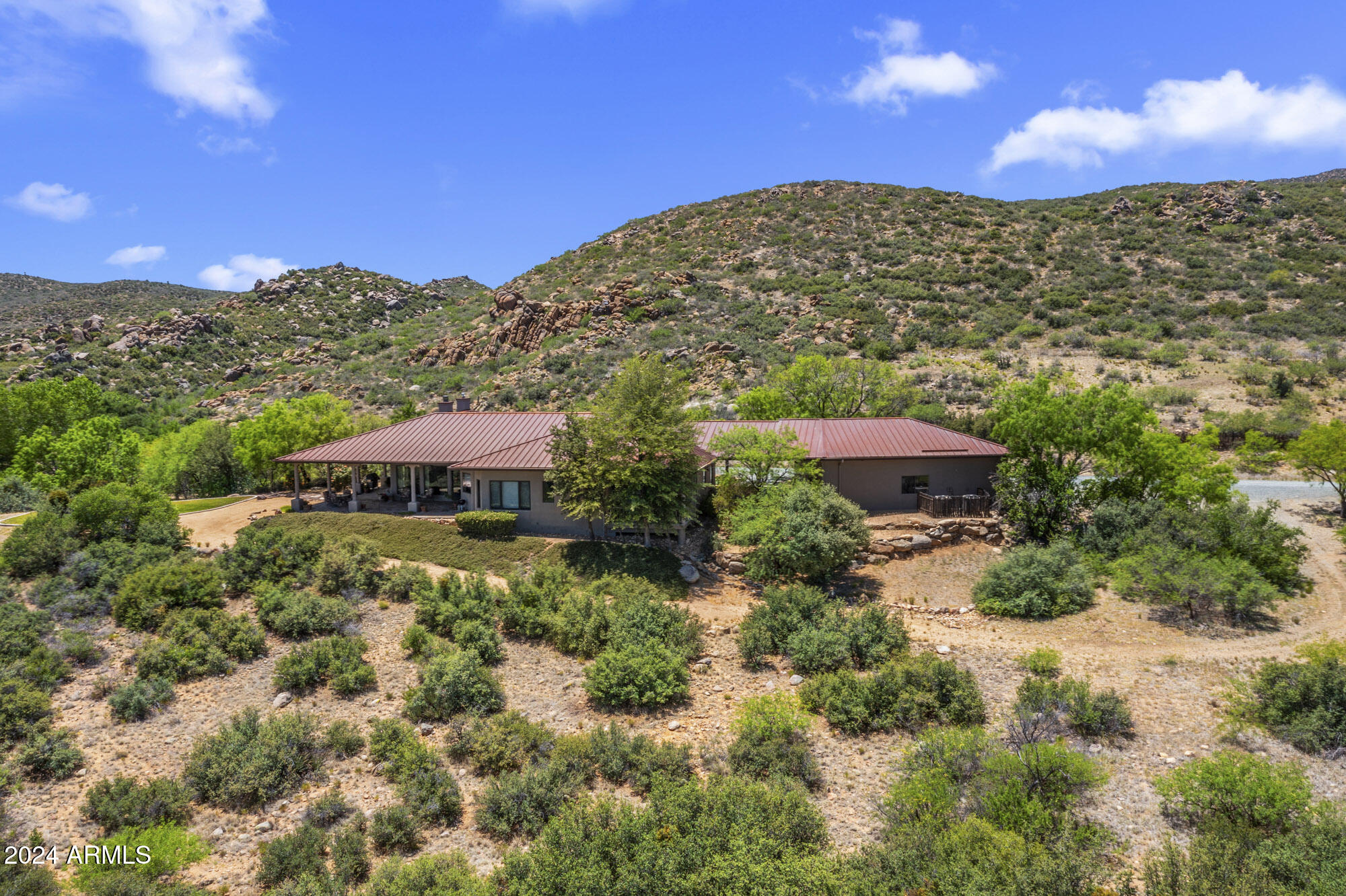 5500 Four Cross Ranch Road Skull Valley, AZ 86338 - Photo 6 of 59 a view of a large garden with mountains in the background