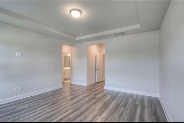 a view of an empty room and wooden floor