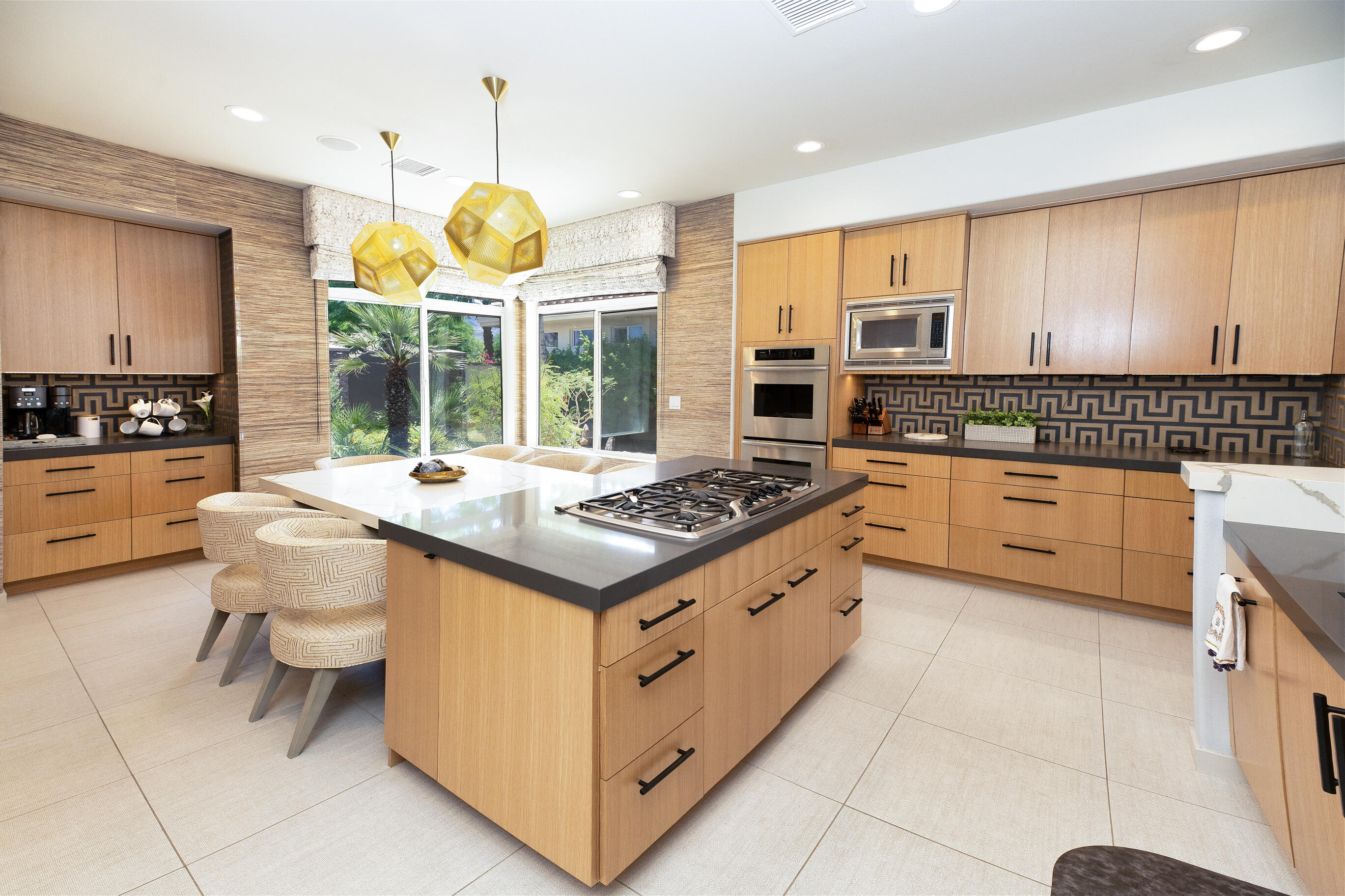12 Varsity Circle Rancho Mirage, CA 92270 - Photo 11 of 59 a kitchen with kitchen island granite countertop a stove a sink and a refrigerator