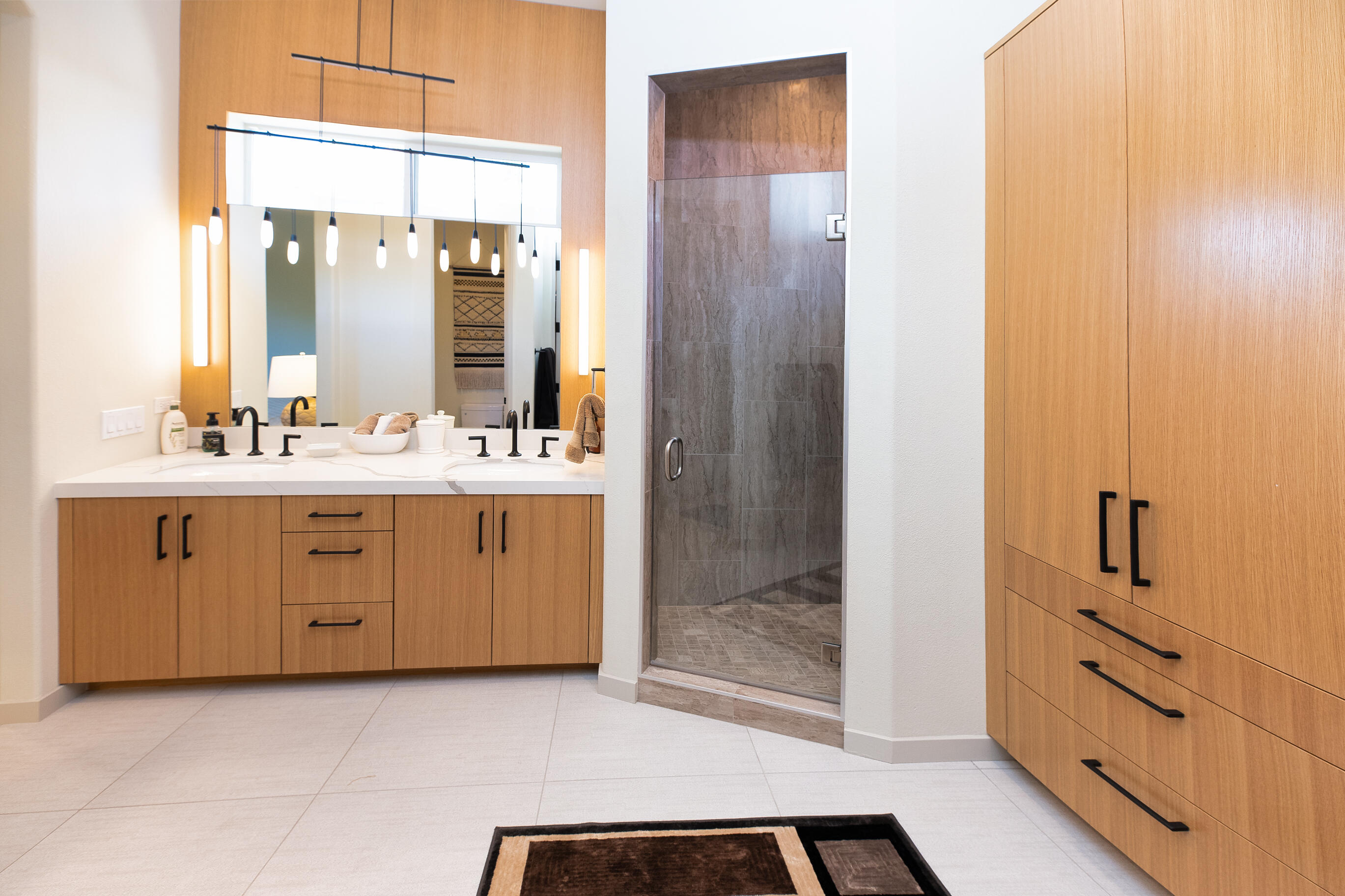 12 Varsity Circle Rancho Mirage, CA 92270 - Photo 27 of 59 a spacious bathroom with a double vanity sink a mirror and a shower