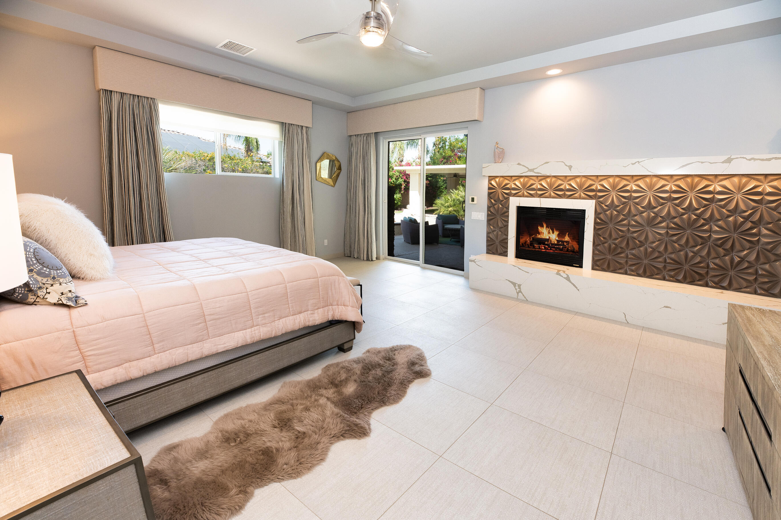 12 Varsity Circle Rancho Mirage, CA 92270 - Photo 29 of 59 a bed room with a bed and a fireplace