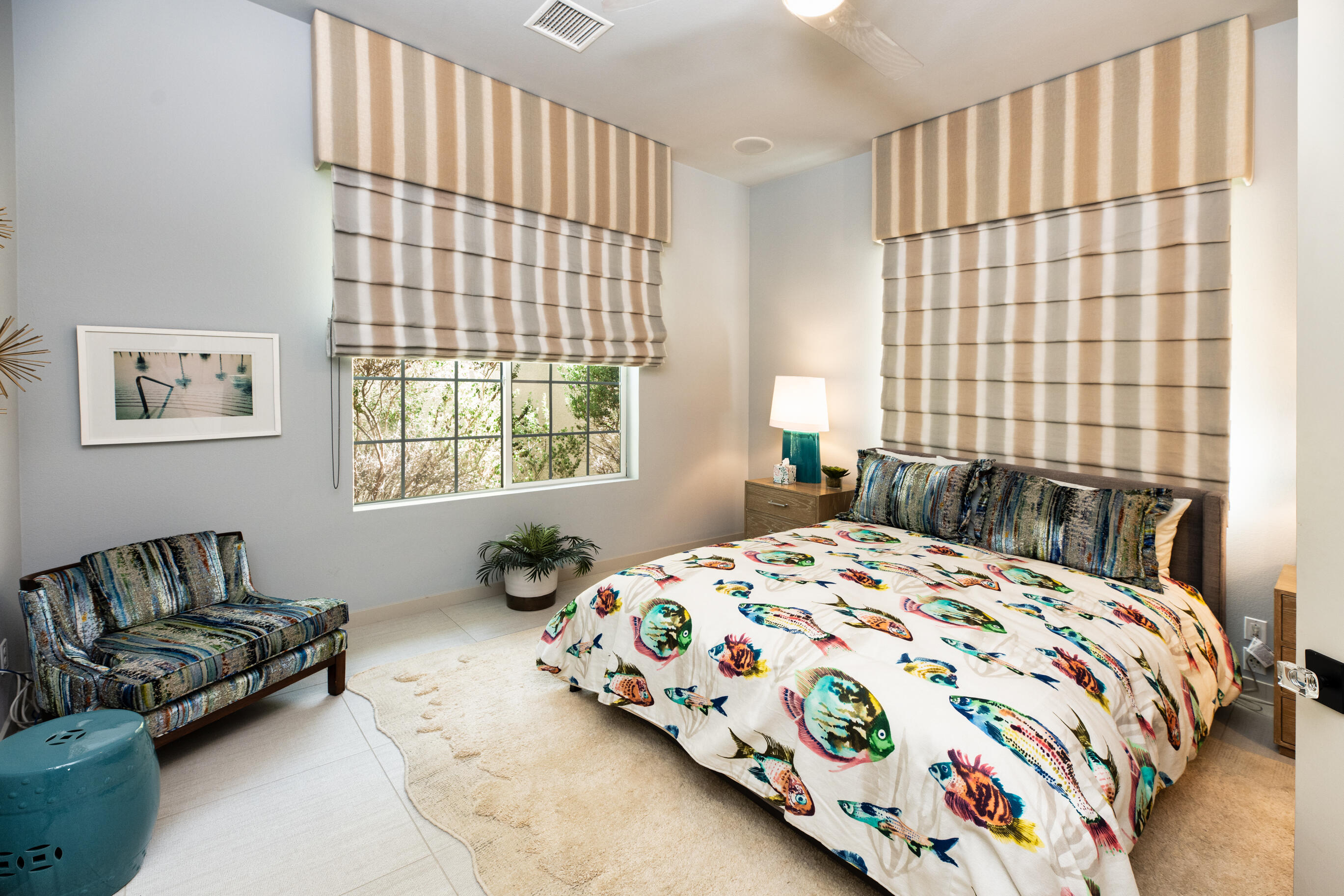 12 Varsity Circle Rancho Mirage, CA 92270 - Photo 34 of 59 a bedroom with a bed and a couch next to a window