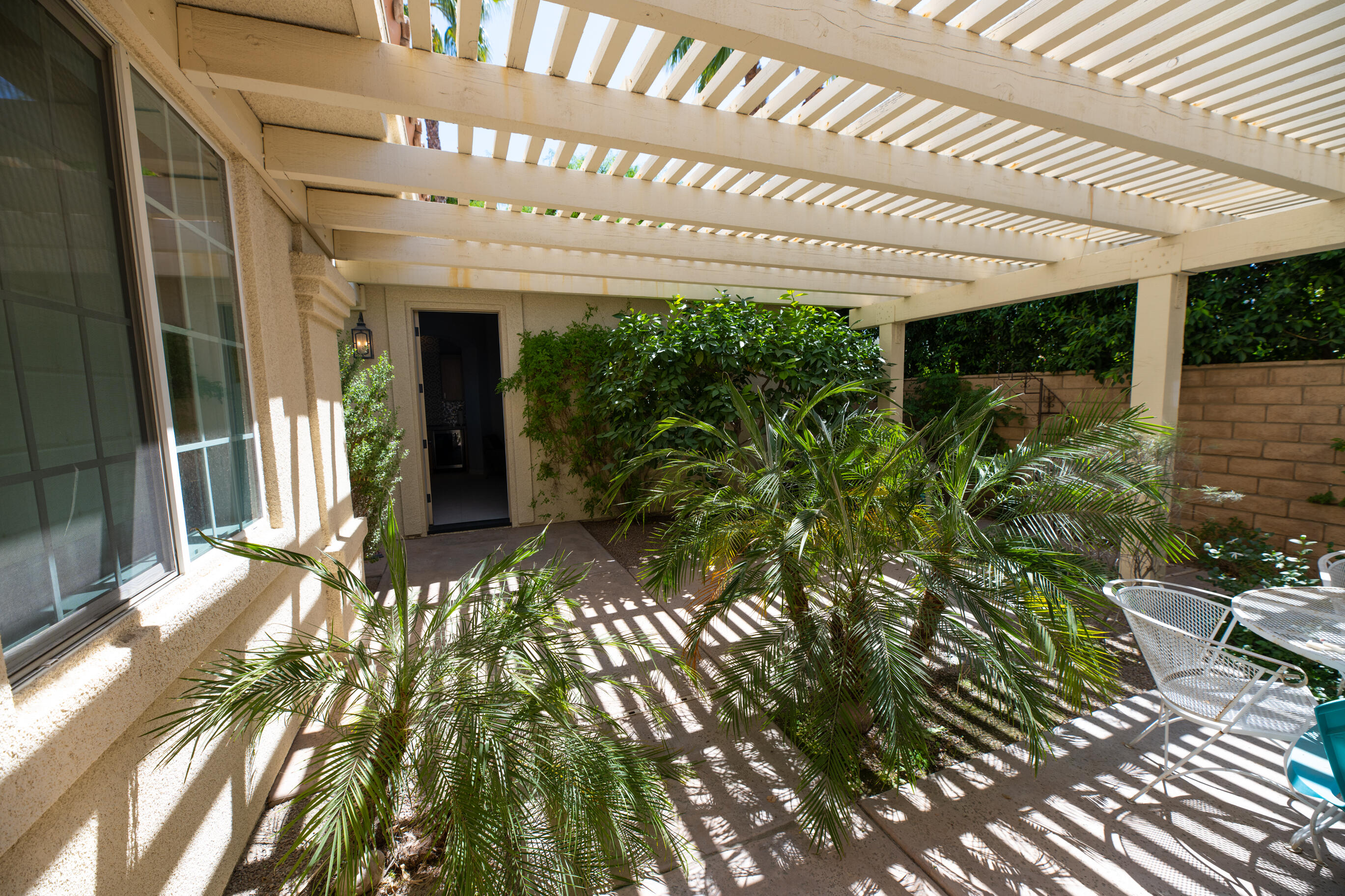12 Varsity Circle Rancho Mirage, CA 92270 - Photo 58 of 59 a front view of a building with a garden