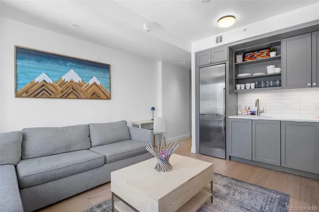 a living room with furniture and a kitchen