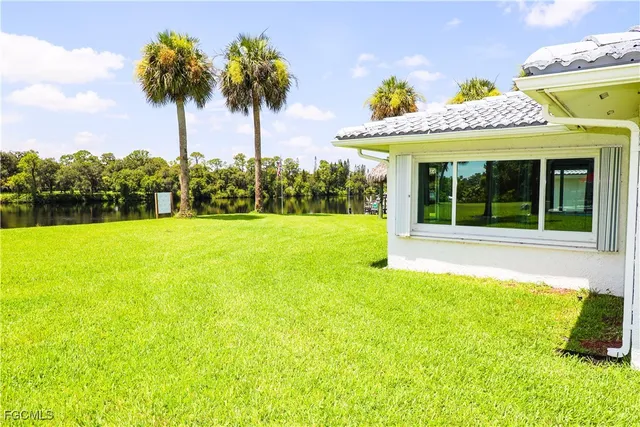 a view of a house with a swimming pool and a porch with furniture