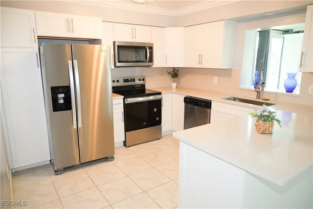 a kitchen with stainless steel appliances a refrigerator stove microwave and sink