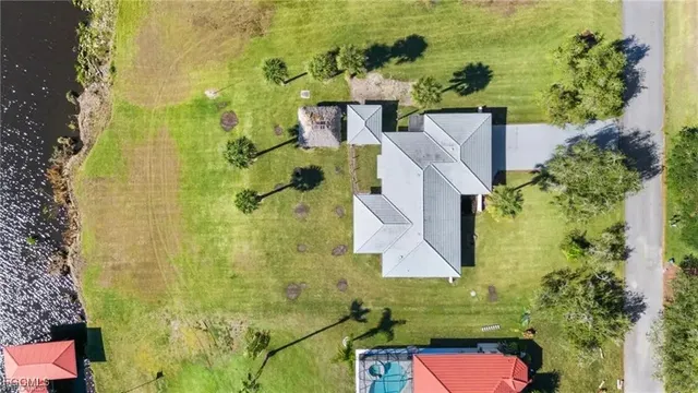 an aerial view of residential houses with yard