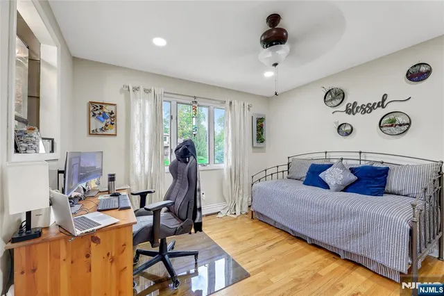 a living room with furniture a window and gym equipment