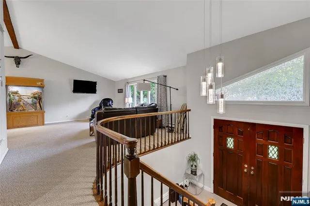 a view of staircase with furniture and chandelier