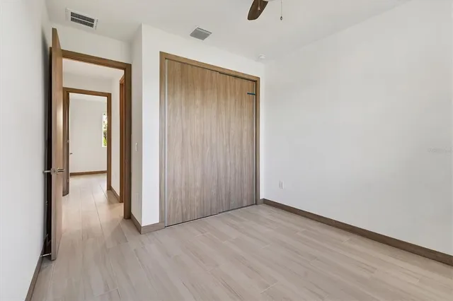 an empty room with wooden floor and a window