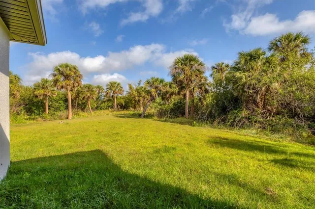 a view of yard with swimming pool and green space