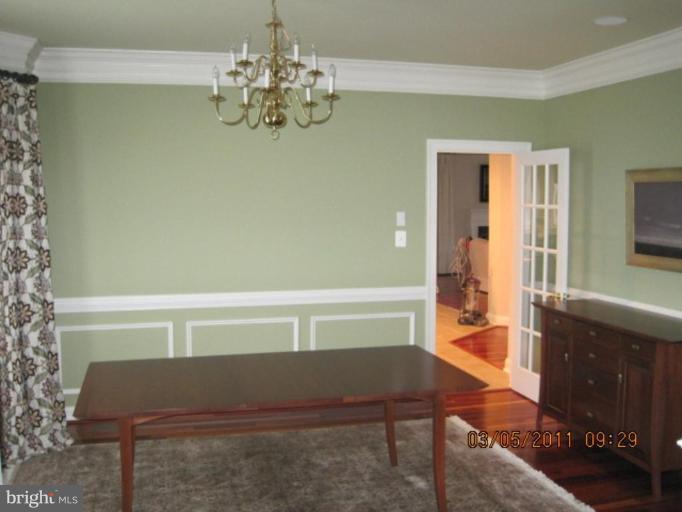 10811 Catron Road Perry Hall, MD 21128 - Photo 11 of 30 a view of a bedroom with furniture and a chandelier