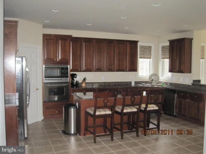 10811 Catron Road Perry Hall, MD 21128 - Photo 16 of 30 a kitchen with a dining table and chairs