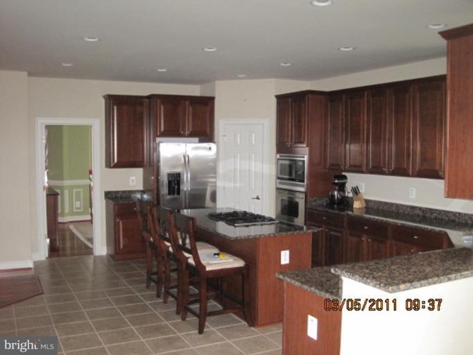 10811 Catron Road Perry Hall, MD 21128 - Photo 17 of 30 a kitchen with granite countertop a sink a stove and refrigerator