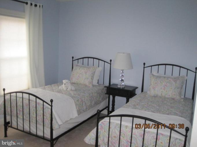 10811 Catron Road Perry Hall, MD 21128 - Photo 25 of 30 a bed sitting in a bedroom next to a window