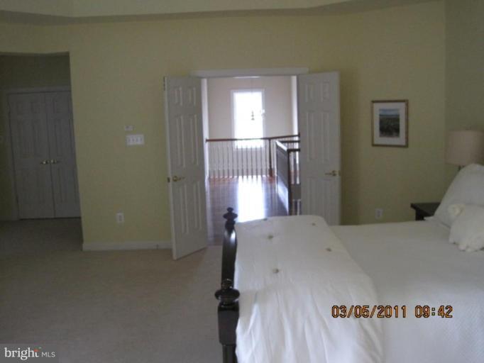 10811 Catron Road Perry Hall, MD 21128 - Photo 28 of 30 a bedroom with a bed and a chandelier