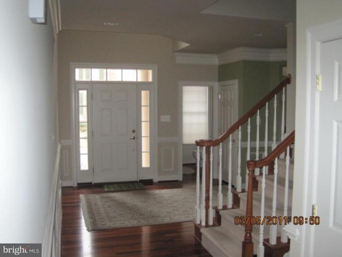 10811 Catron Road Perry Hall, MD 21128 - Photo 7 of 30 a view of staircase with white walls and windows