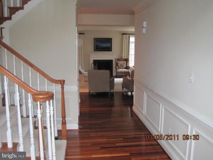 10811 Catron Road Perry Hall, MD 21128 - Photo 9 of 30 a view of a hallway with wooden floor and staircase