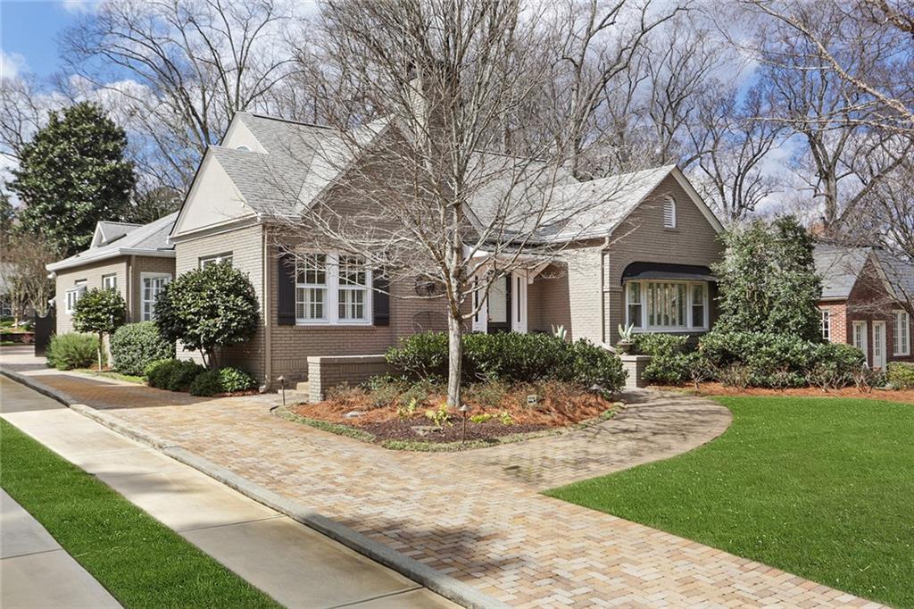 a front view of a house with yard and green space
